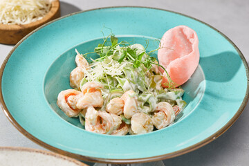 Elegant Pasta with Shrimp in Creamy Sauce on Vibrant Plate with Fresh Garnish