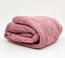 Soft, folded, knitted throw blanket in a delicate rose-pink hue