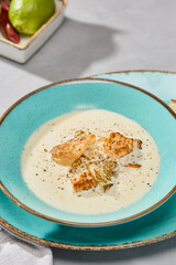 Creamy Fish Soup with Rustic Charm in a Vibrant Blue Bowl