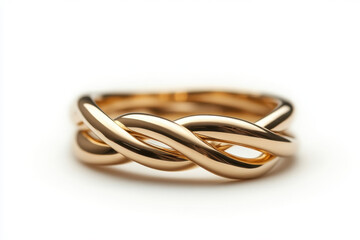 Fototapeta premium Gold ring with a twisted design gleaming under soft light.