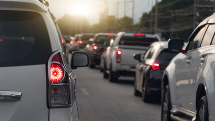 Transportation luxury of white cars on the road. Open light brake waiting to release traffic signals in the intersection. Heavy traffic. Many cars in queue and traffic jam.