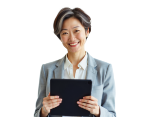 Business portrait isolated on white transparent background: A confident Asian woman with short, silver-streaked hair smiles warmly while holding a tablet in front of her, dressed in a gray suit and 