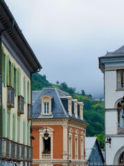 Obraz premium Charming historic buildings line the street with detailed facades and balconies in village in France