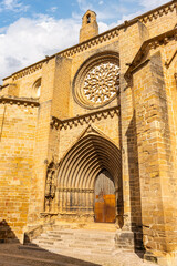 Facade with large wooden door of the medieval church in the village of Valderrobres, Matarrana.