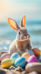 Adorable Easter bunny sitting among colorful speckled eggs, soft pastel background with blurred ocean waves creating a dreamy springtime scene