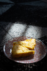 Serving Pumpkin Pie Slices on Decorative Plate in Sunlight
