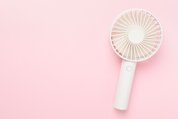 Mini electric fan on color background, top view