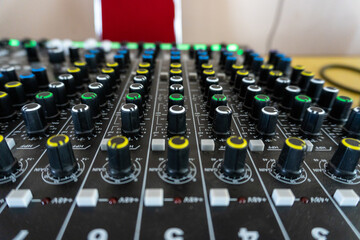 Adjusting Sound Mixer Console with Knobs and Faders for Audio Engineering