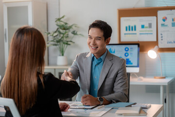 Colleagues shaking hands during a productive office meeting