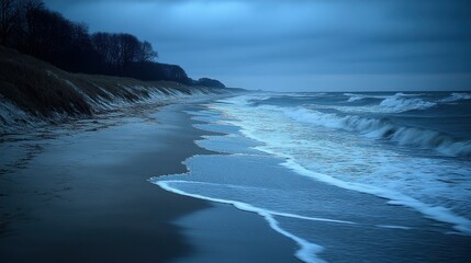 Serene twilight beach scene with gentle waves lapping at the shore under a cloudy sky