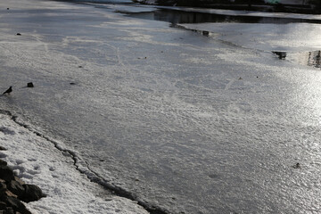 The surface of the river is covered with ice and snow.