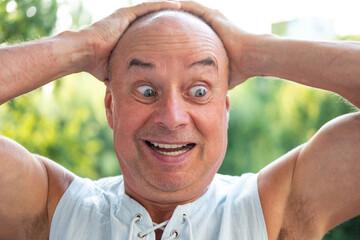 humorous senior man with twinkle in eye poking fun at himself, embracing life's simple pleasures,...