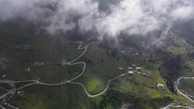 A footage of a mountain village, a plateau, located in a valley surrounded by alpine meadows, among high mountains.