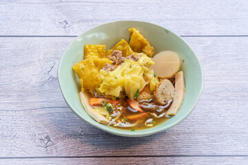 Tom Yum noodles, spicy soup with pork, fish balls, morning glory, bean sprouts
