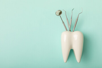 Dentist tools on a blue background. Dentist Concept.Teethcare, dental health concept. Means to care for the oral cavity. Dental model and dental equipment. Dental hygiene. Space for text. Copy space.