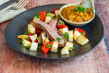 Lamb with smoky pepper sauce and saute potatoes