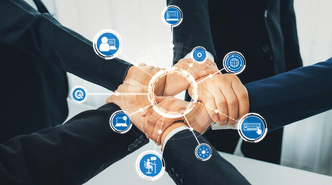 A united group of diverse professionals showcasing teamwork with connected hands and modern technology icons, symbolizing collaboration and innovation in business environments. Amity