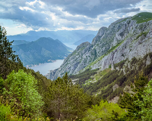 Obraz premium Kotor Bay, Montenegro, Mountainous landscape with a bay and cloudy sky