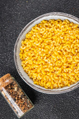 Macaroni pasta raw coquillette appetizer dish organic product fresh tasty gourmet food background on the table rustic food top view copy space