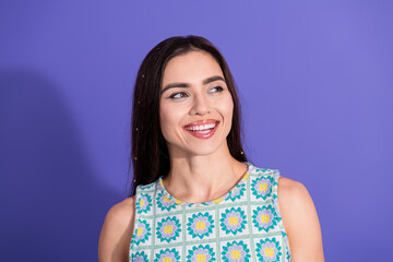 Fototapeta premium Smiling Young Woman with Long Dark Hair in a Stylish Summer Top Against a Purple Background
