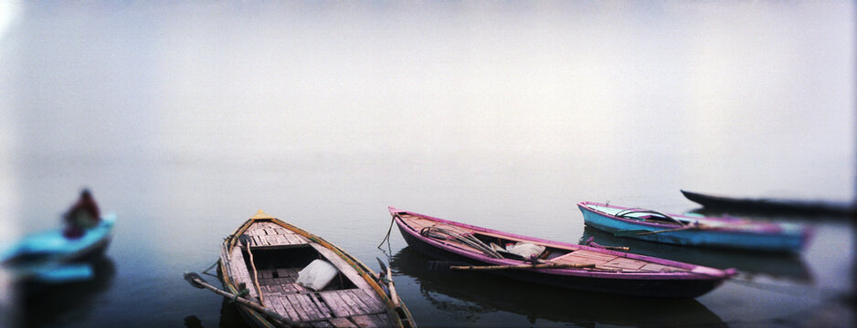 Panoramic image of row boats in a river, Ganges River, Varanasi, Uttar Pradesh, India.
