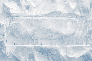 Obraz premium Natural textured ice block with frozen air bubbles structure and internal cavity surrounded with crushed ice.