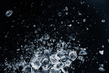 Ice, crushed on a black background. A heap of crushed ice.