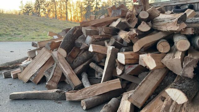 heap of firewood being delivered to home with tractor