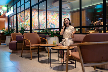 Young businesswoman talking on phone while sitting in cafe