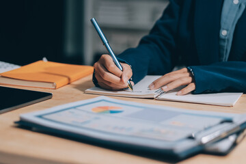 Portrait of Asian young female working on laptop at office