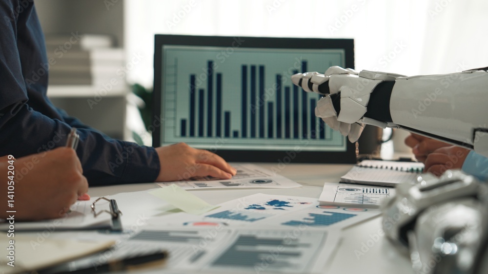 Poster a human and robotic hand interact in a collaborative business environment, analyzing data charts on 