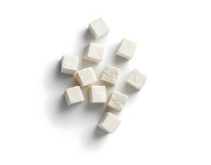 Feta cheese cubes with basil leaves isolated on a white background