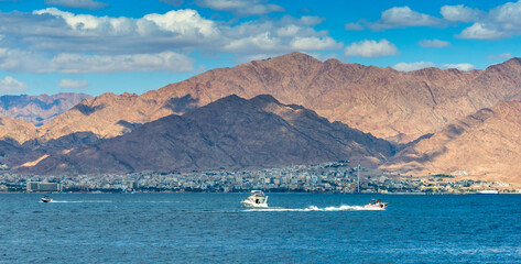 Water sport with ski surfing and motorboat, recreation activities and style of life, sunny and windy day on the Red Sea