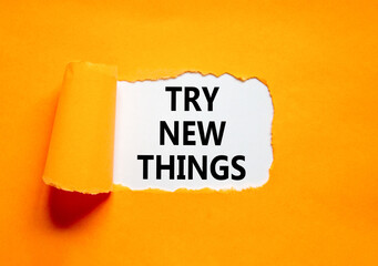 Try new things symbol. Concept words Try new things on beautiful white paper. Beautiful orange paper background. Business motivational lifestyle try new things concept. Copy space.