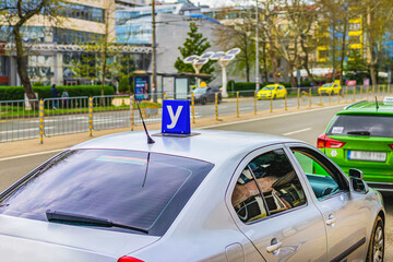 Car with Driving school blue sign on roof used in Bulgaria. Sign training vehicle. Learning driving skills in driving school. Concept of driver license, traffic rules