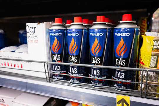 Metal cans of butane gas on a store shelf for consumer purchase