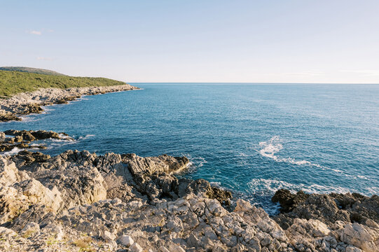 View from the rocky shore to the blue sea