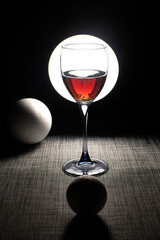 Still life with wine glass and foam balls