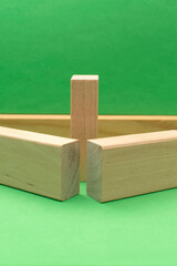 Still life with wooden blocks on green background
