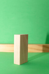Still life with wooden blocks on green background