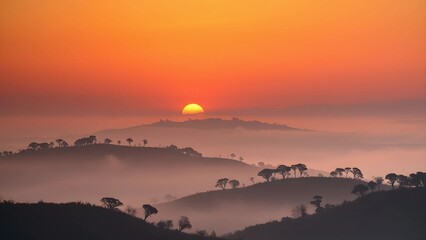 Fototapeta premium Early Summer Sunrise Over Misty Hills