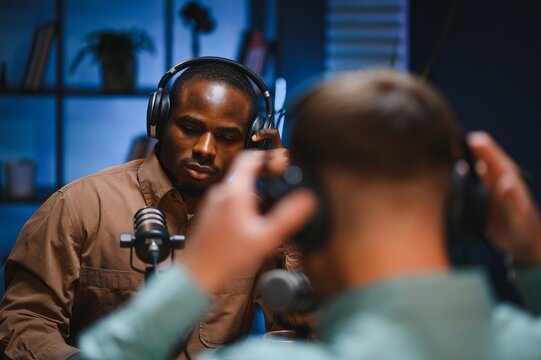Man recording podcast using high tech microphones to interview guest, ensuring flawless video and sound quality for audience