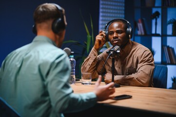 Podcast presenter having live discussion with man, streaming it for audience on internet...