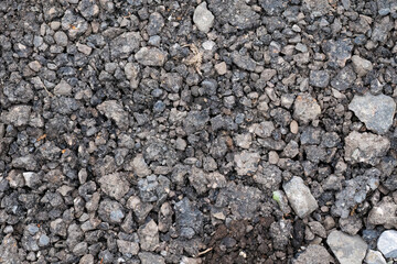 Close-up of rough asphalt rubble surface
