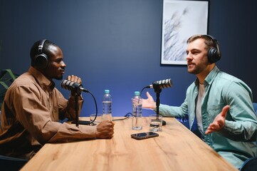 Man recording podcast using high tech microphones to interview guest, ensuring flawless video and...