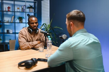 Podcast presenter having live discussion with man, streaming it for audience on internet...