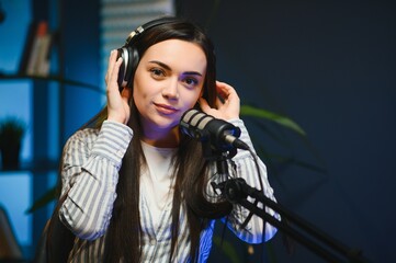 woman records podcast, speaking into microphone