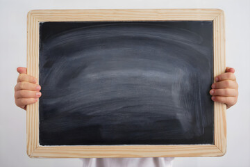 kid holding blank blackboard with chalk