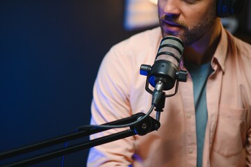 Focus on the microphone and headphones. Podcast studio or recording studio