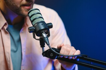 Focus on the microphone and headphones. Podcast studio or recording studio